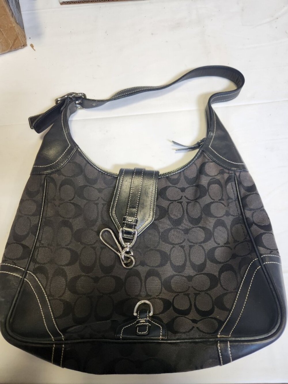 Black canvas and leather Coach Hamilton hobo bag features the brand's signature